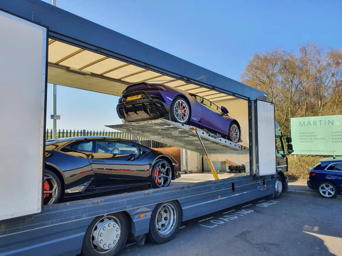 Luxury cars in an enclosed trailer - GT1 luxury sourcing and delivery